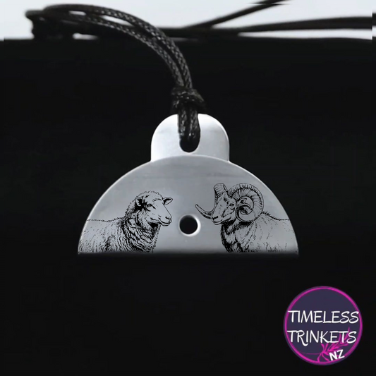 Metal dog whistle with engraved images of a ewe and a ram. Made from stainless steel