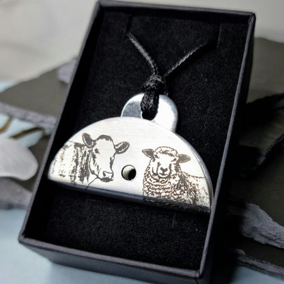Stainless steel dog whistle with engraved sheep and cow design in a black gift box