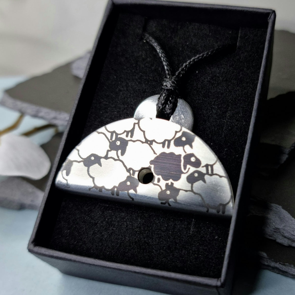Stainless steel shepherds whistle
pendant with black and white sheep pattern in a black gift box